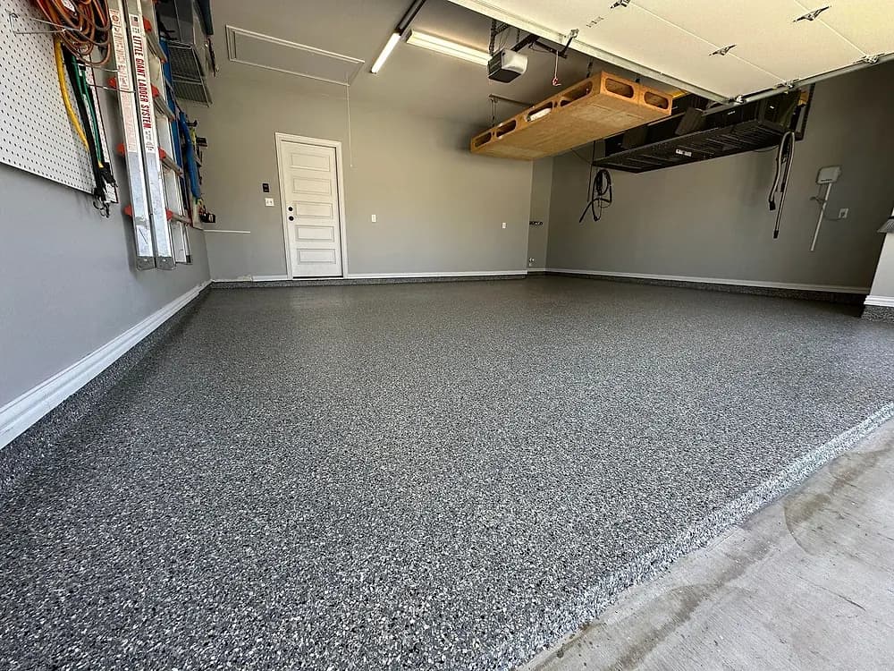 Wide view of a finished flake garage floor toward the garage door