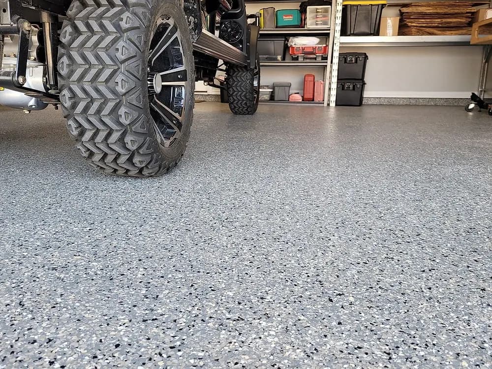Coated garage floor with a golf cart parked on it