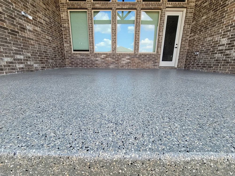 Coated patio behind a brick home